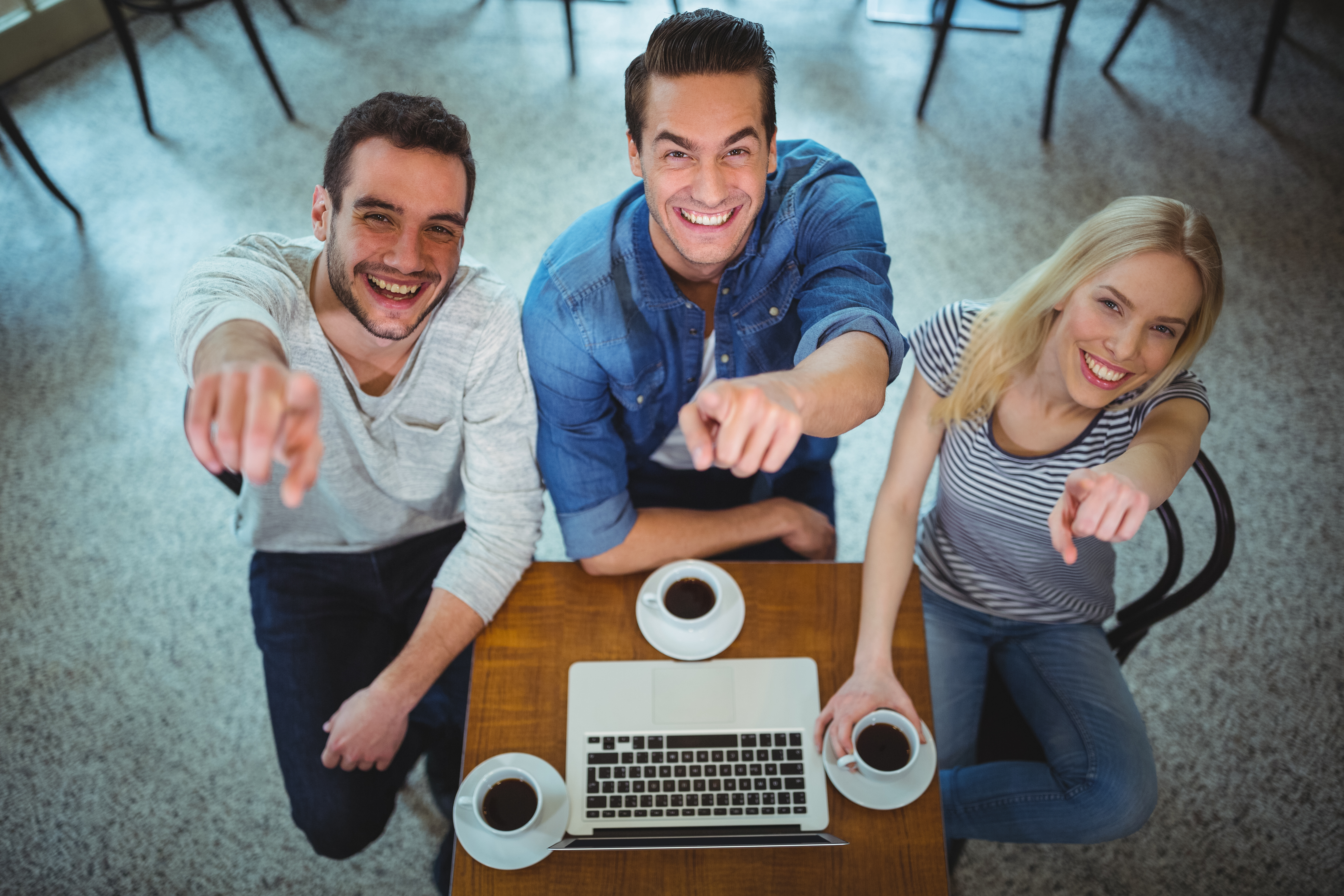 friends-pointing-camera-while-having-black-coffee